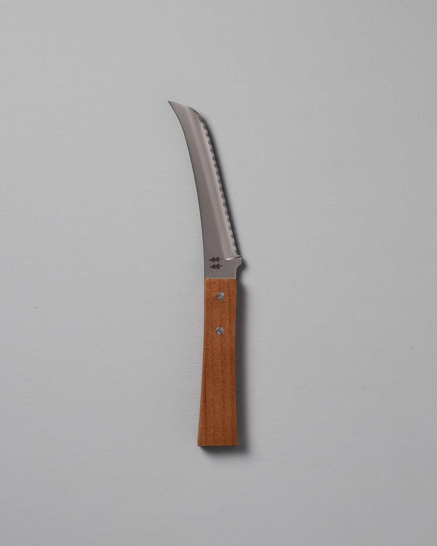 The Morinoki Soft Cheese Knife by Shizu Hamono Co., featuring a serrated blade and Japanese Zelkova handle, is shown vertically against a plain light gray background.