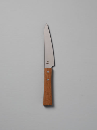 The Morinoki Petite Knife from Shizu Hamono Co. boasts an ergonomic grip and sleek stainless steel blade, complemented by a wooden handle, elegantly displayed against a light gray background.