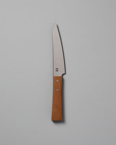 The Morinoki Petite Knife from Shizu Hamono Co. boasts an ergonomic grip and sleek stainless steel blade, complemented by a wooden handle, elegantly displayed against a light gray background.