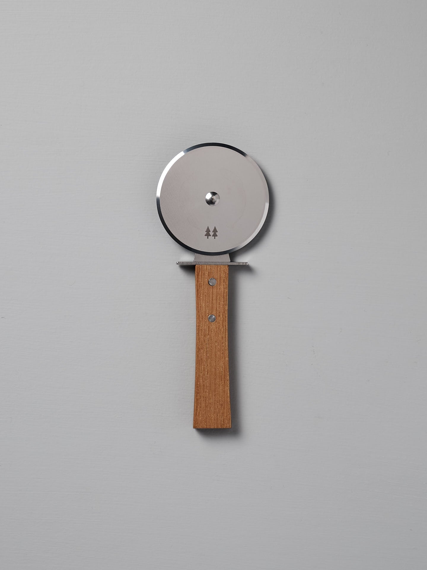 The Morinoki Pizza Wheel by Shizu Hamono Co., featuring a stainless steel blade and Japanese Zelkova handle, is positioned vertically against a plain light gray background.