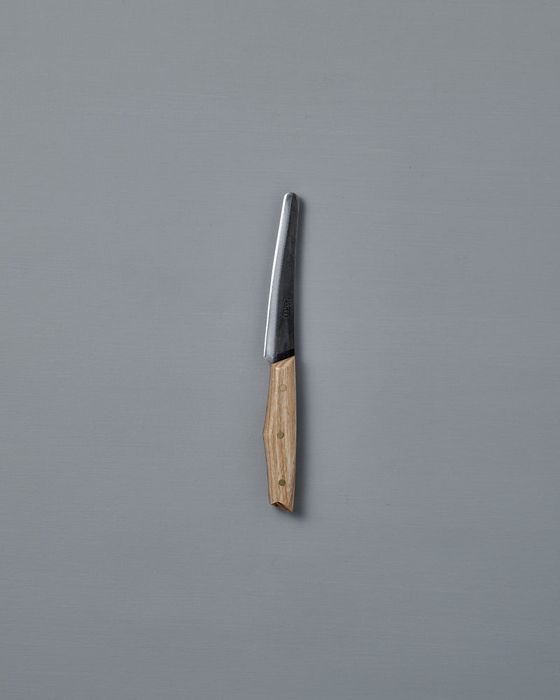 The №1 – Spread Knife, featuring a handcrafted wooden handle and a Swedish carbon steel blade, is displayed vertically against a plain gray background.