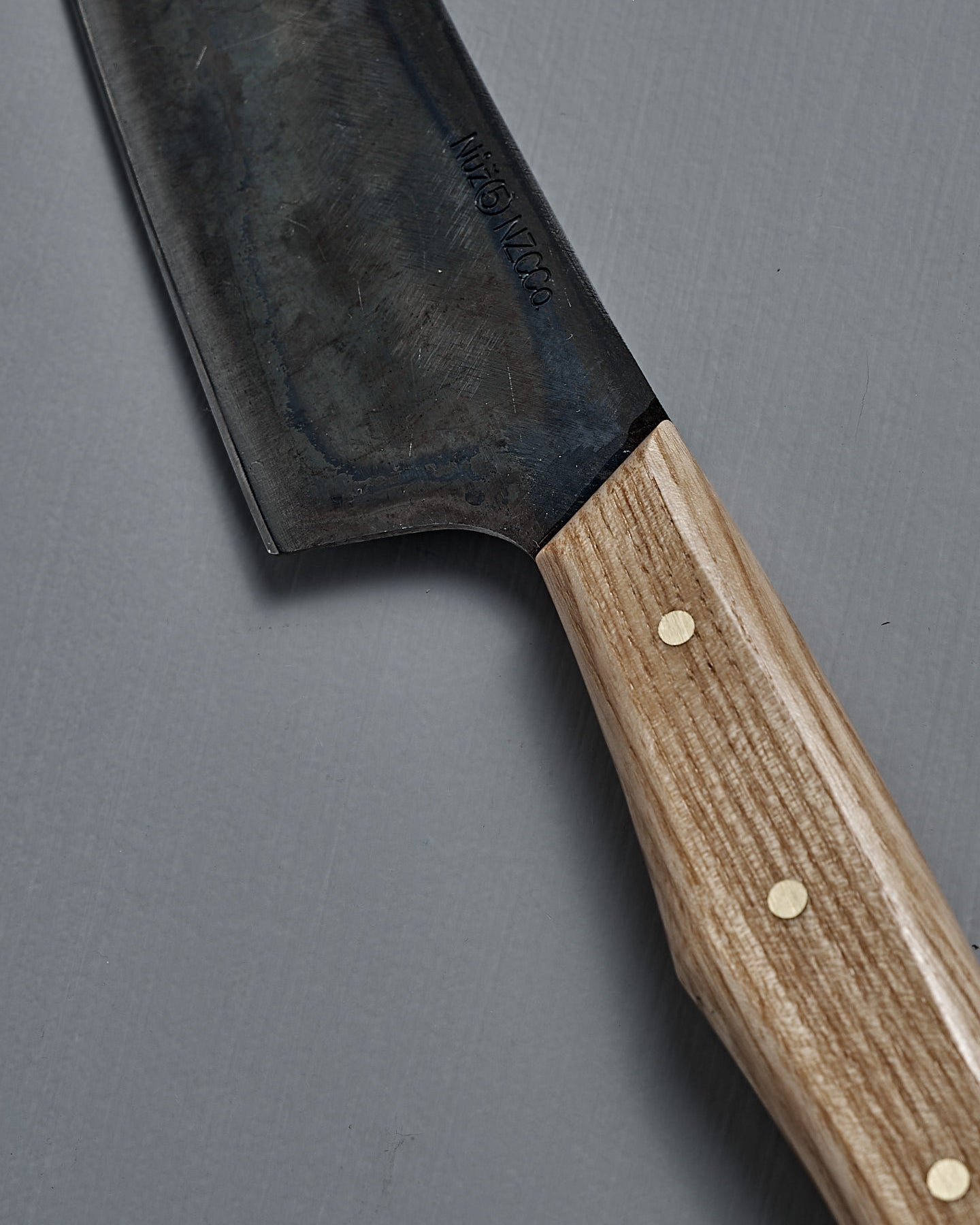 The №5 – Gourmet Knife, a large handcrafted kitchen knife with a dark Swedish carbon steel blade and a light wooden handle, is displayed on a plain grey background.