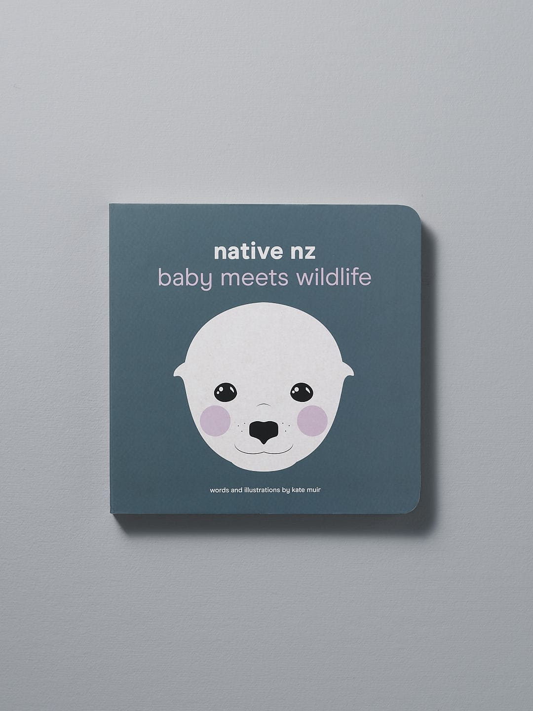 A board book titled "Native NZ Baby Meets Wildlife" by Kate Muir with an illustration of a stylized animal on the cover.