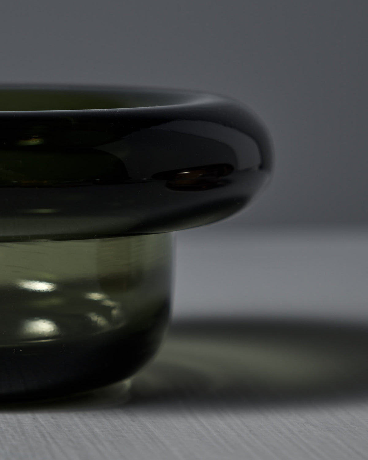 Close-up of a glossy Sirkel Candle Holder–Forest Green by Nedre Foss on a light surface, casting a soft shadow.