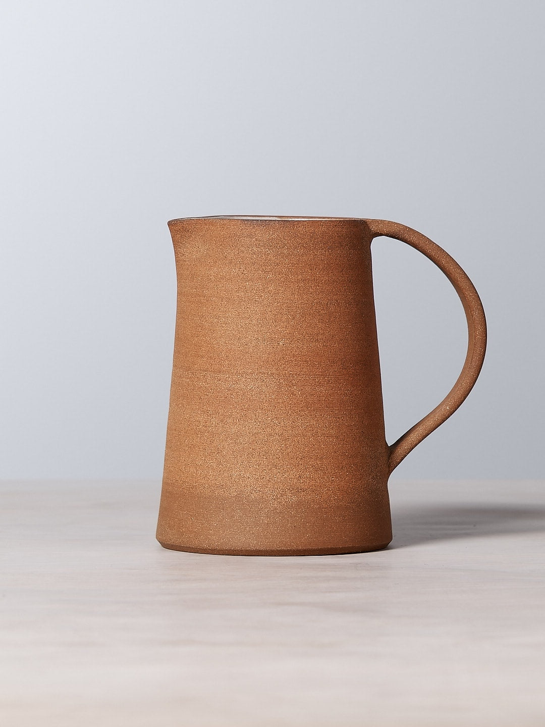 A Nicola Shuttleworth Textured jug sitting on top of a table.
