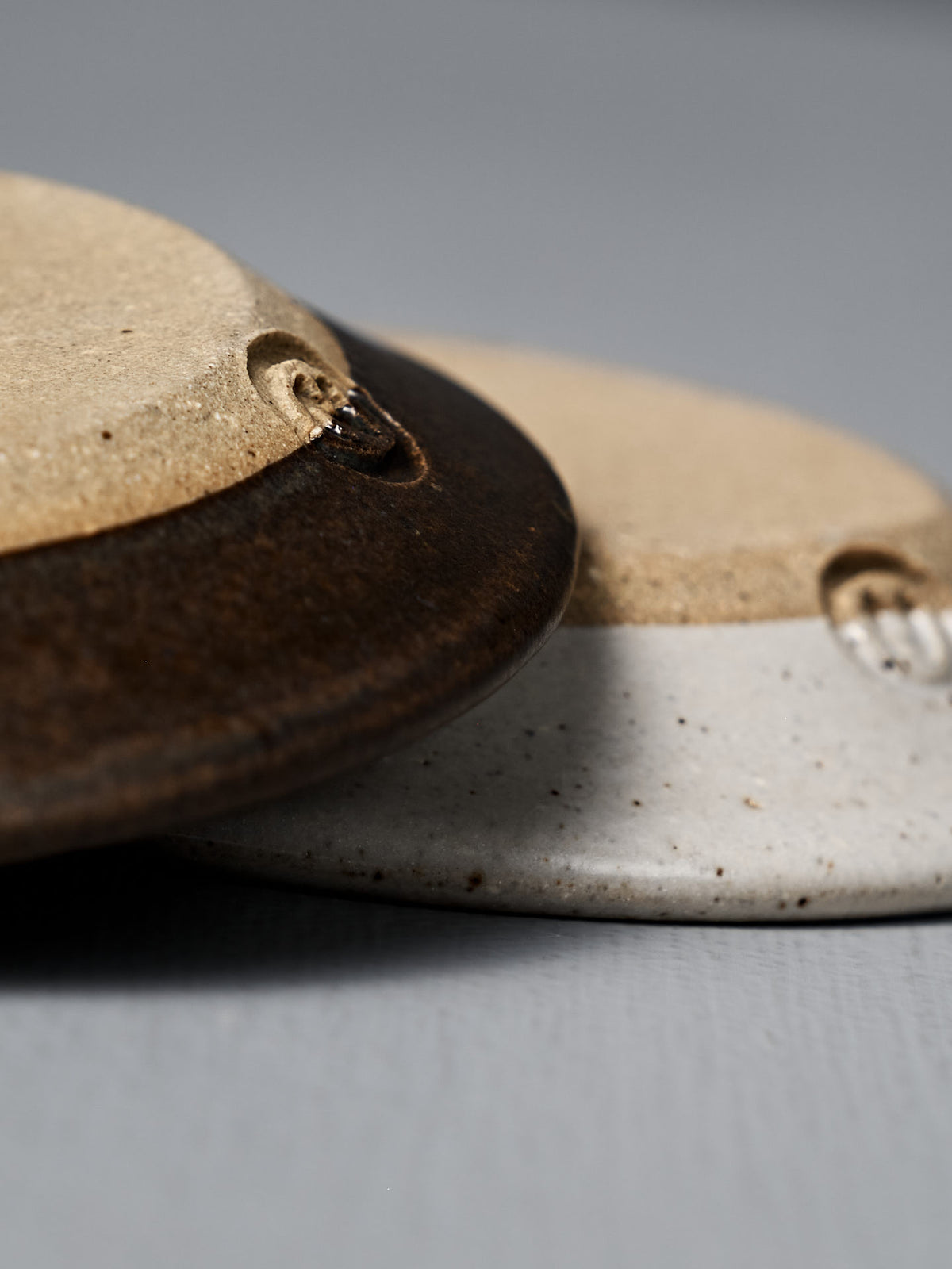 Close-up of the Incense Holder – Brown, a handmade stoneware piece in earthy tones, displayed on a gray surface.
