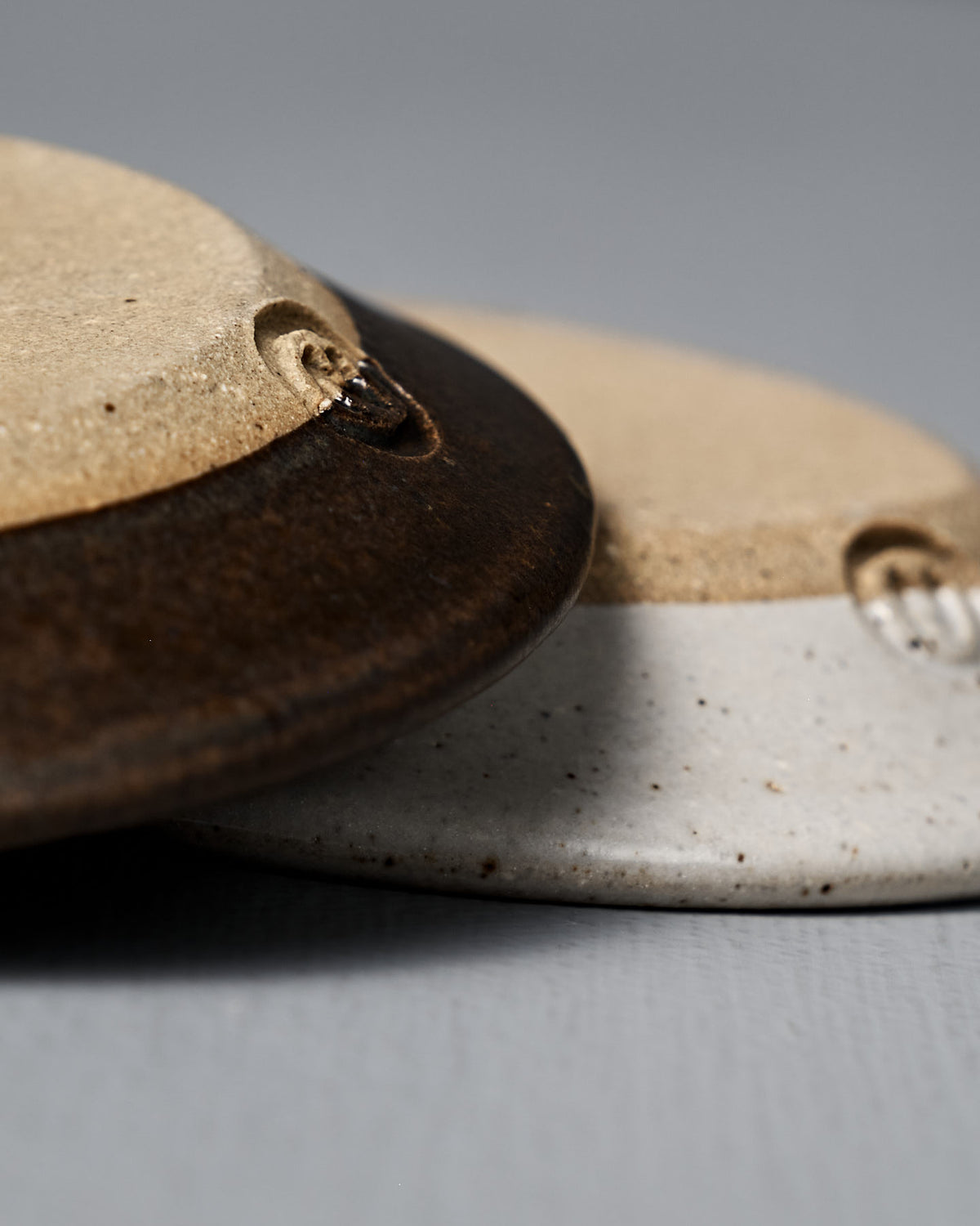 Close-up of the Incense Holder – Brown, a handmade stoneware piece in earthy tones, displayed on a gray surface.