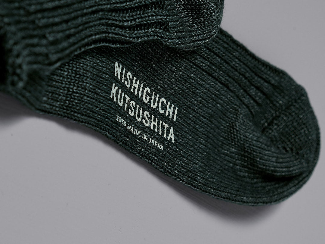 A close up of a pair of Praha Linen Ribbed Socks – Beach Plants by Nishiguchi Kutsushita.
