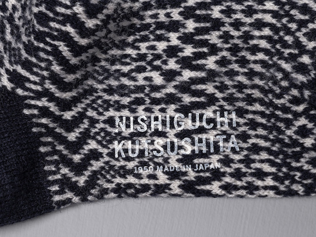 A close up of Oslo Wool Jacquard Socks – Navy by Nishiguchi Kutsushita, made of pre-shrunk wool for incredible warmth.