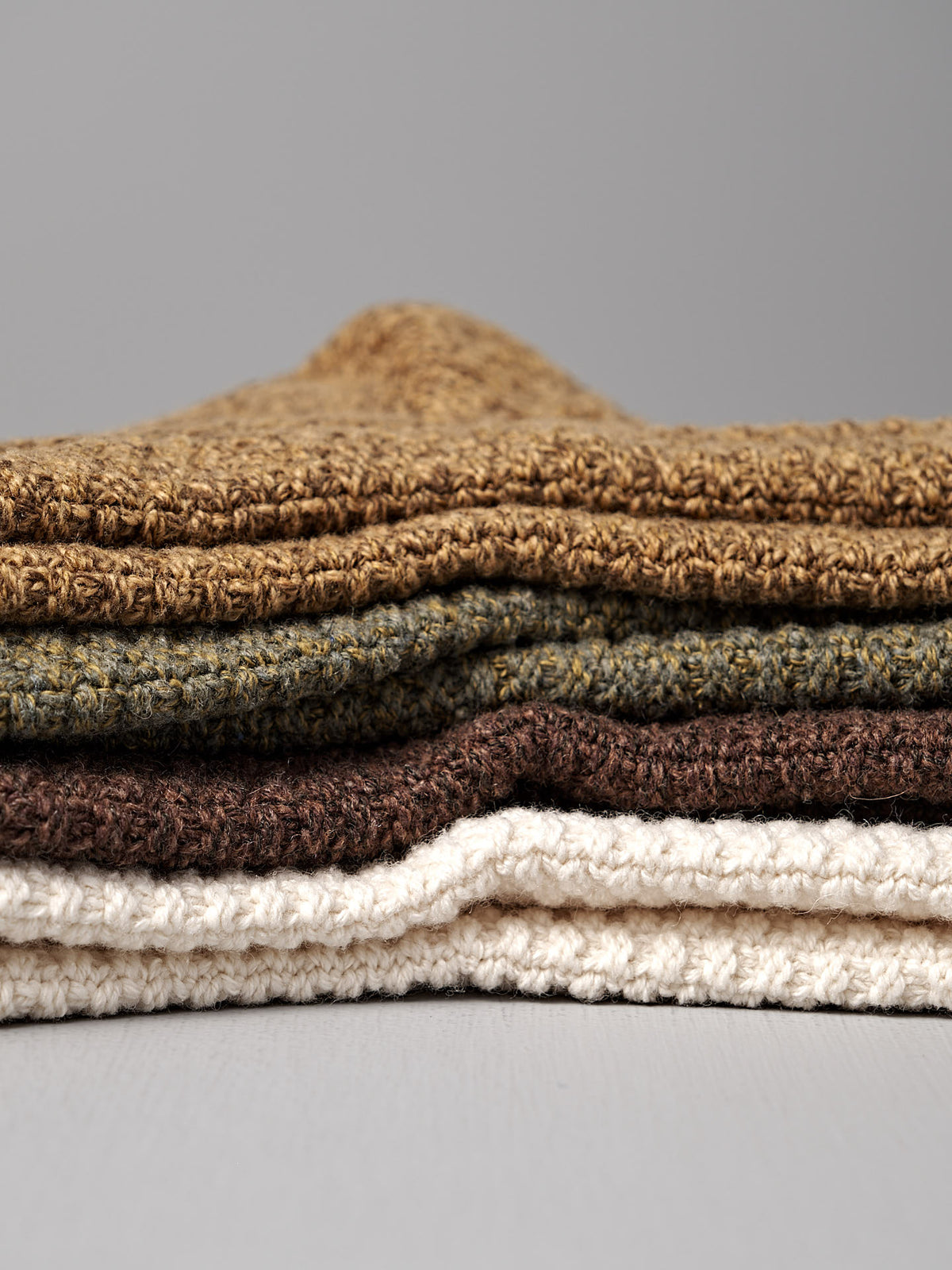 A pair of Wool Cotton Boot Socks in brown by Nishiguchi Kutsushita rests on a light surface—earthy, textured, and perfect for cozy comfort while you browse the men&#39;s size chart.