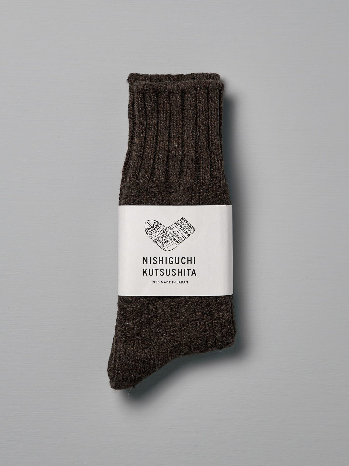 A pair of Wool Cotton Boot Socks – Brown labeled &quot;Nishiguchi Kutsushita,&quot; designed to fit US Men&#39;s sizes, placed against a plain gray background.