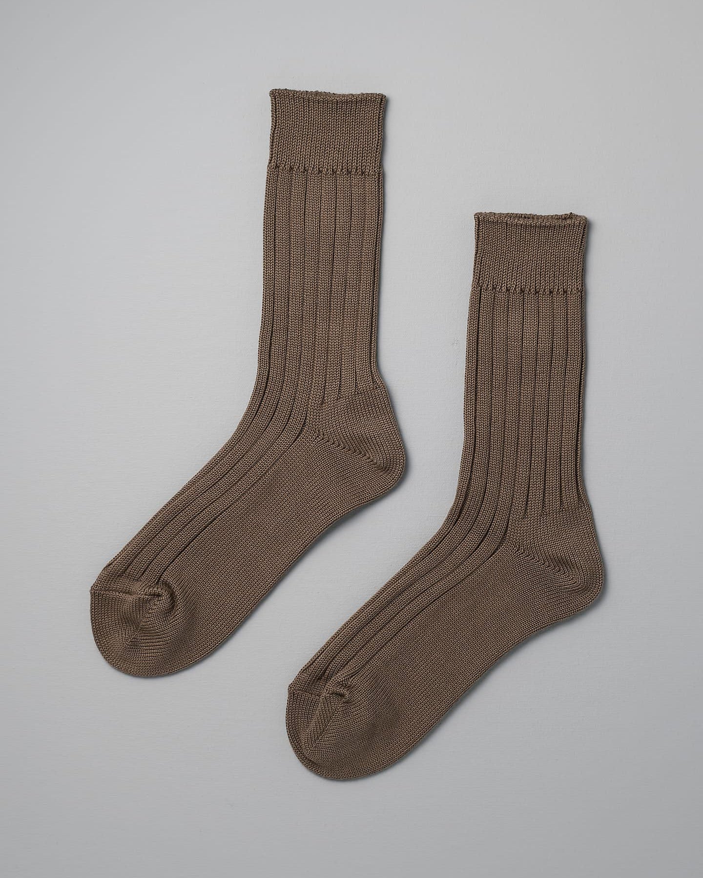 A pair of Praha Cotton Socks – Chocolate Milk by Nishiguchi Kutsushita laid flat on a light grey background, perfect to complement both men's and women's shoes. Check the size guide for the best fit across EUR and US sizes.