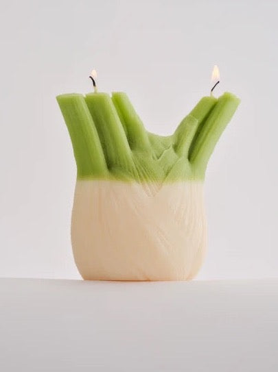 A hand-made Nonna's Grocer Fennel Candle made from a soy wax blend, designed to resemble a piece of celery.