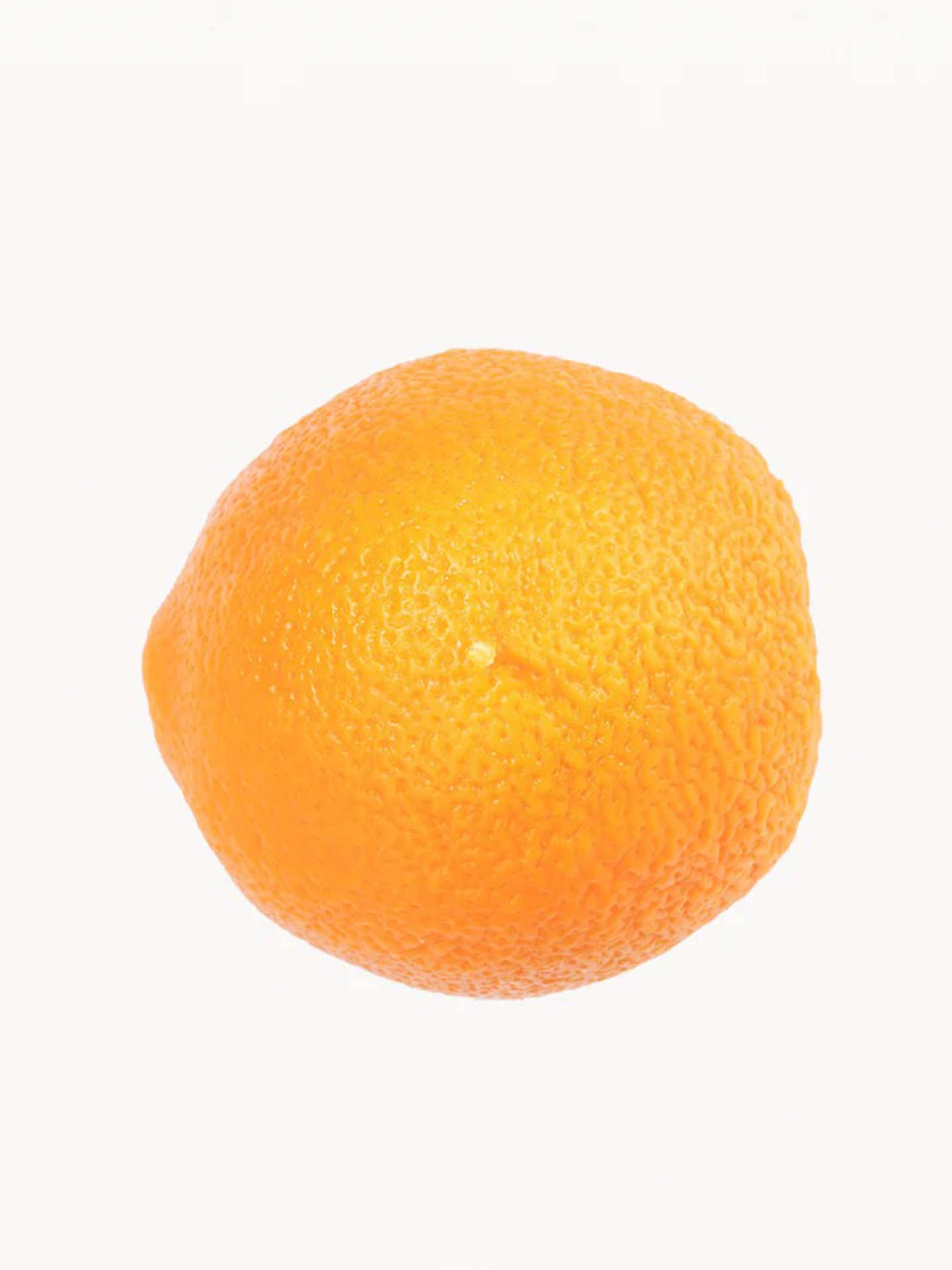 A scented orange candle, created by Nonna&#39;s Grocer and designed to mimic the appearance of a textured, bumpy orange peel, is displayed against a plain white background.