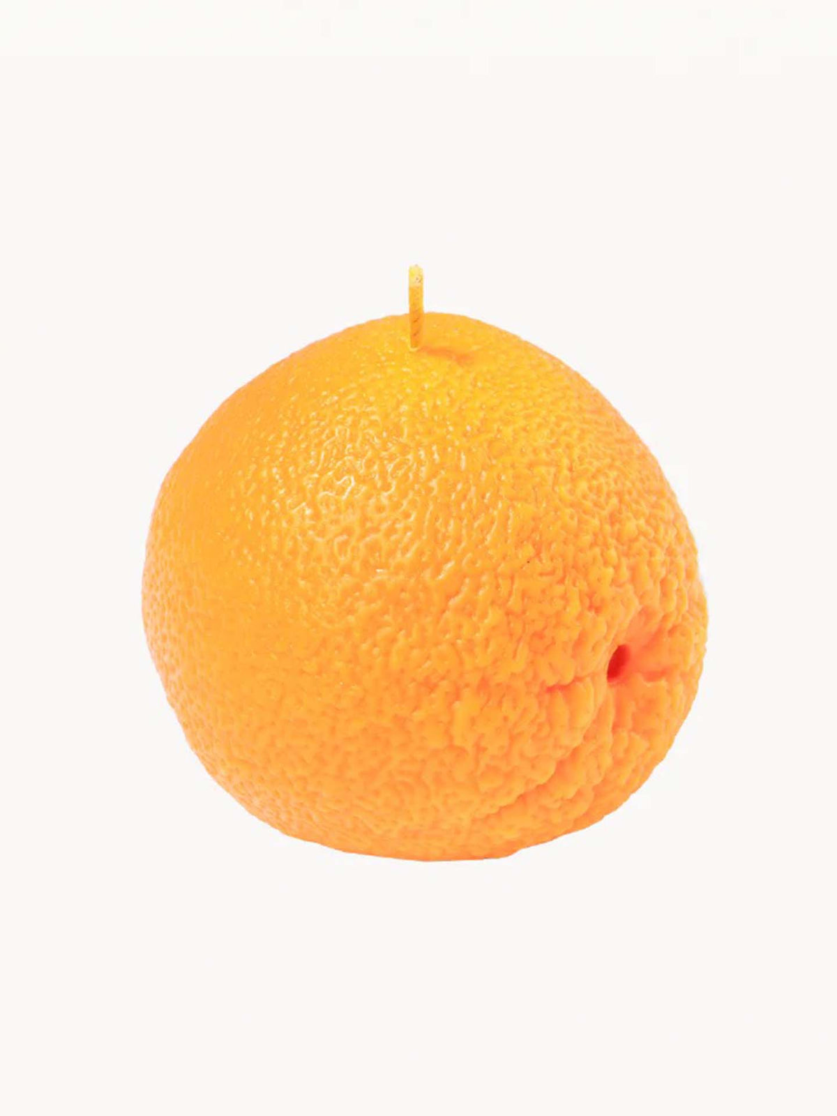 Introducing the Scented Orange Candle by Nonna&#39;s Grocer: a beautifully crafted piece made from natural soy wax, expertly shaped like a realistic orange with a textured surface that mimics orange peel and features a visible wick on top.