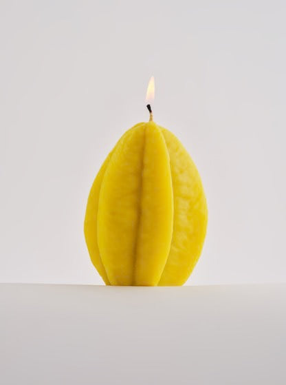 A Nonna&#39;s Grocer Starfruit Candle – Large, made with a soy wax blend, sitting on a white surface.