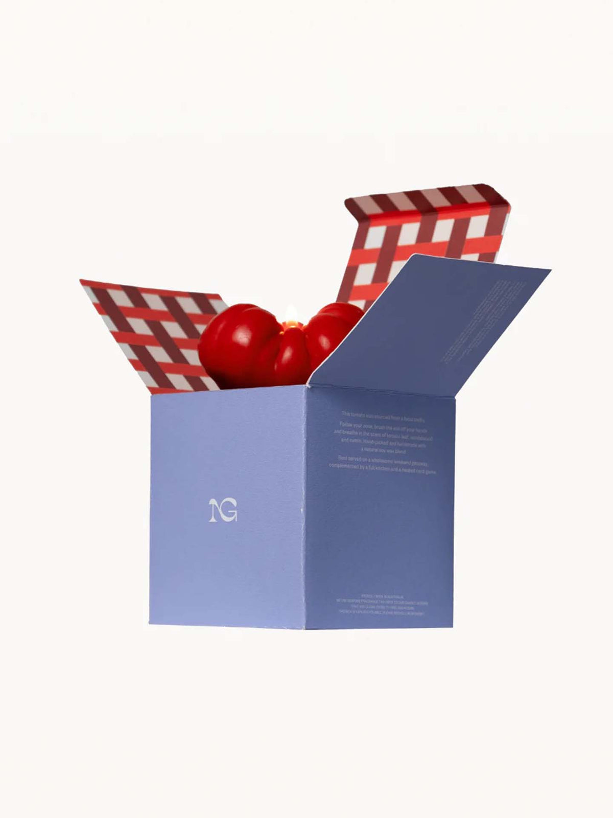 A blue container with an open lid reveals two red bell peppers nestled inside, reminiscent of Nonna&#39;s Grocer&#39;s signature Scented Tomato Candle. The interior of the lid features a charming red and white checkered pattern, similar to a picnic blanket, giving this hand-crafted presentation an artisanal appeal that enhances any kitchen decor.