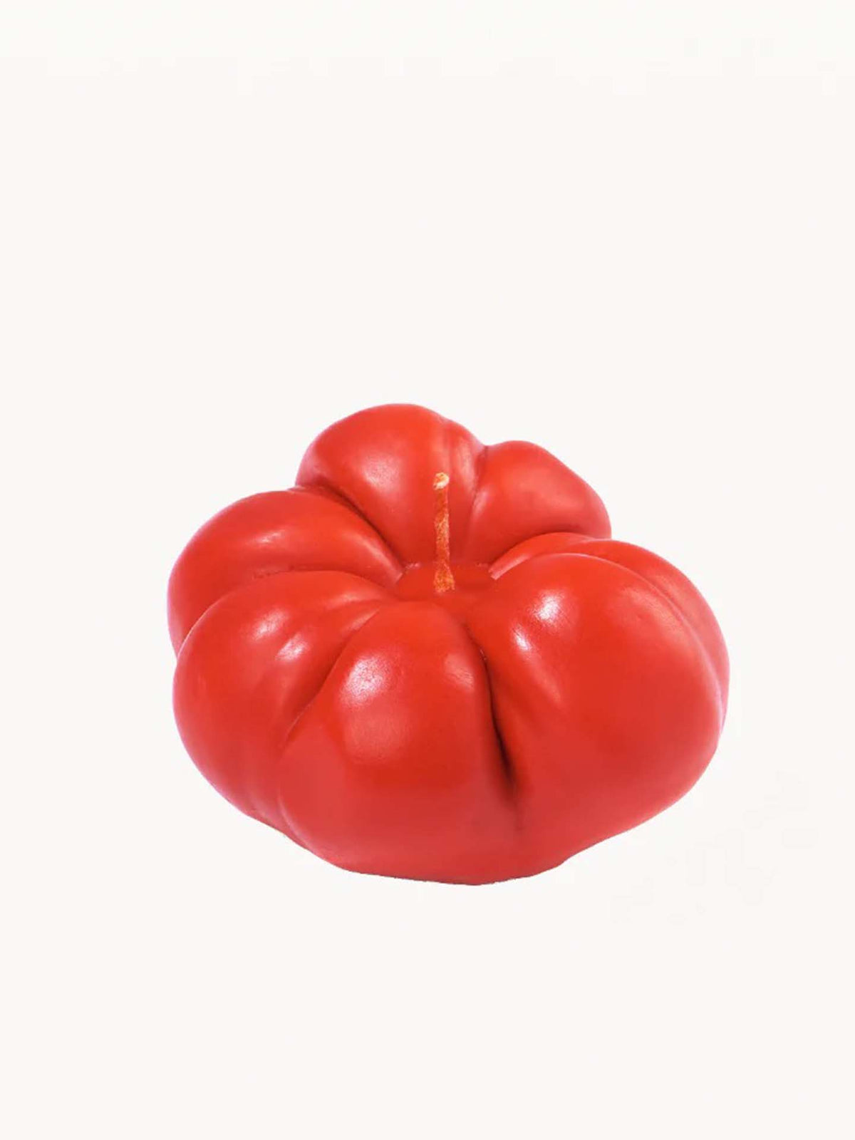 Handcrafted candle made from a soy wax blend, designed to resemble a red tomato, by Nonna&#39;s Grocer, set against a plain white background.