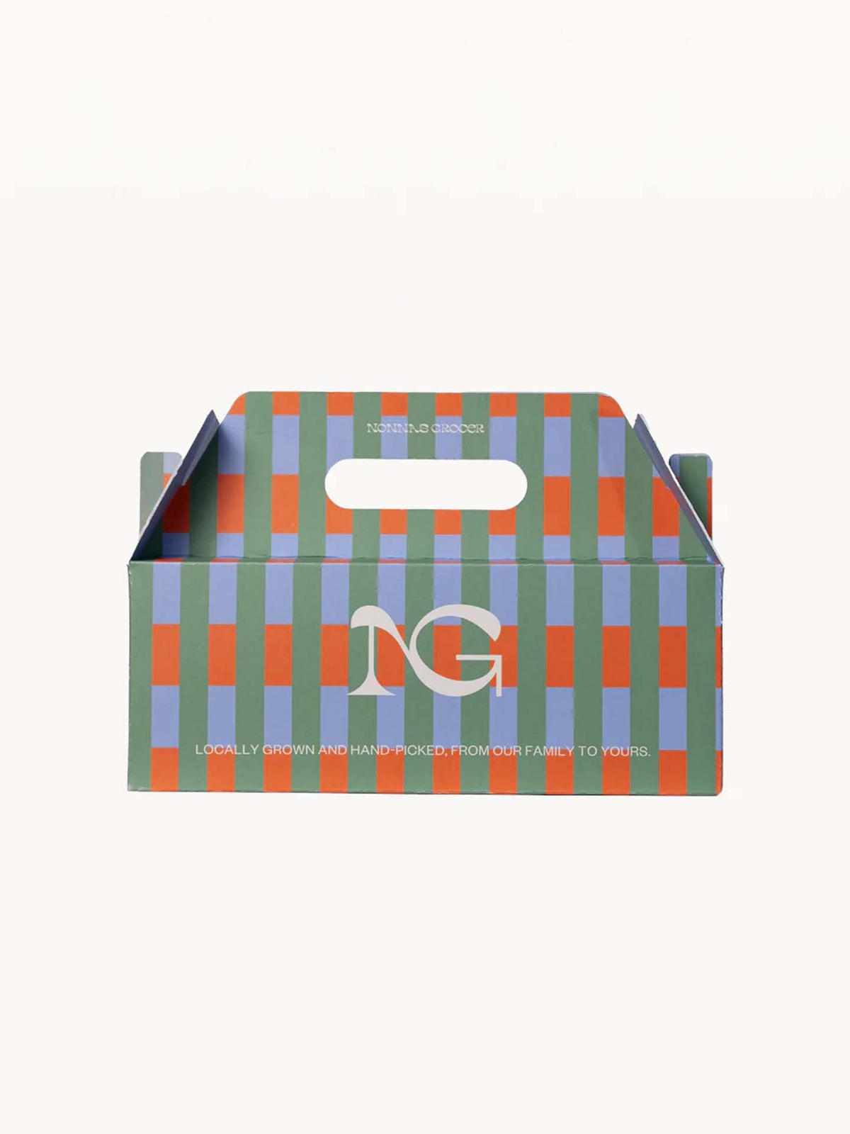 A vibrant cardboard gift box featuring a green, blue, and orange checkered pattern with a convenient handle. The text reads &quot;Locally grown and handpicked, from our family to yours.&quot; Ideal for housing the Scented Trio Pack – Lemon, Tomato, Orange by Nonna&#39;s Grocer, made with natural soy wax.