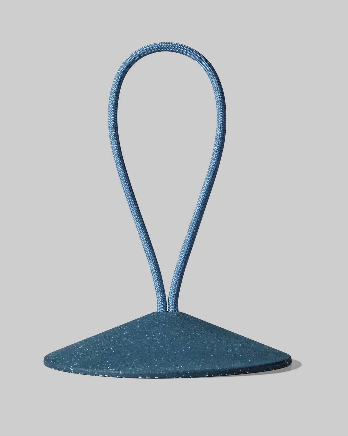 A blue cone-shaped object with a looped blue cord extending upward from its top, set against a plain gray background.