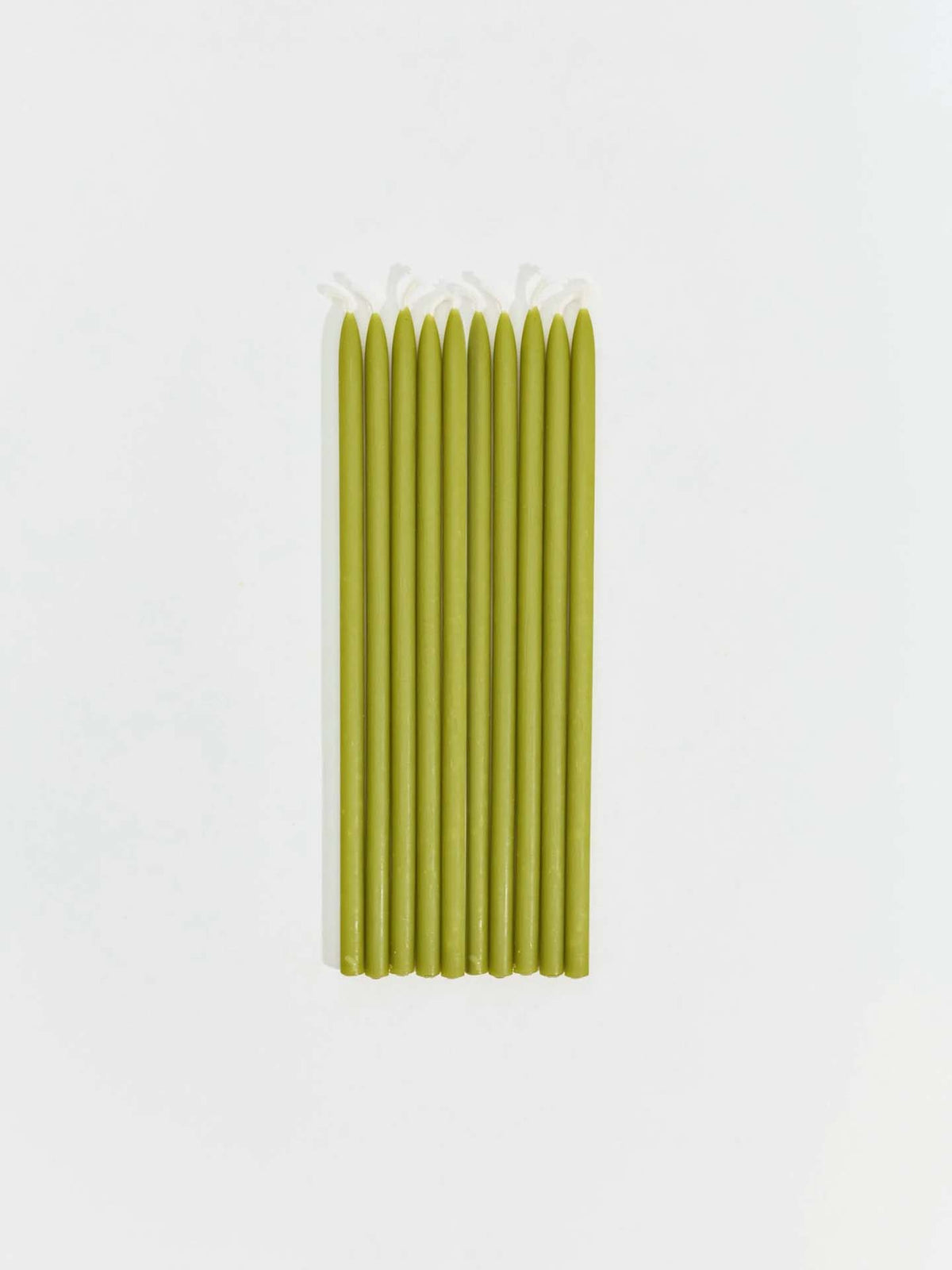 Nine Tall Celebration Candles – Mix & Match in green are arranged in a row on a plain white background.