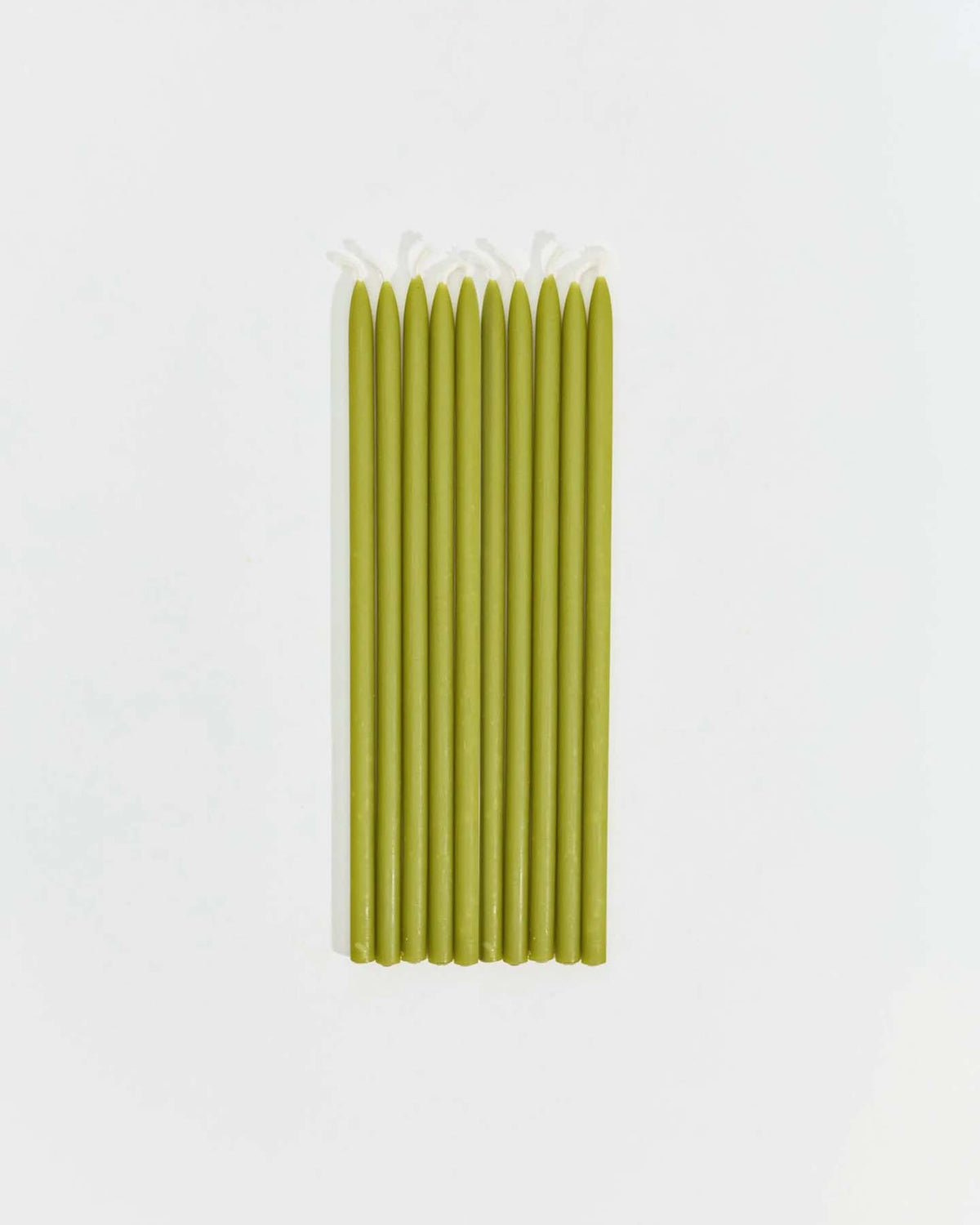 Nine Tall Celebration Candles – Mix & Match in green are arranged in a row on a plain white background.