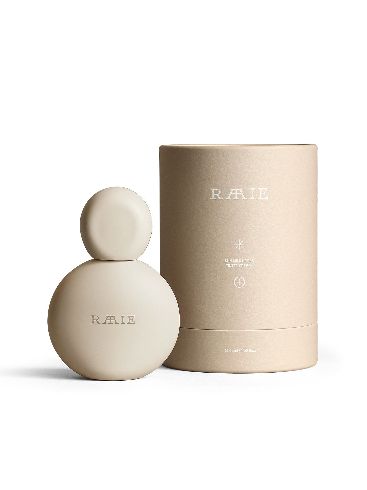 A beige, round perfume bottle with the brand name "RAAIE" embossed, standing next to a matching cylindrical container, evokes the elegance of Sun Milk Drops Tinted SPF 50+.