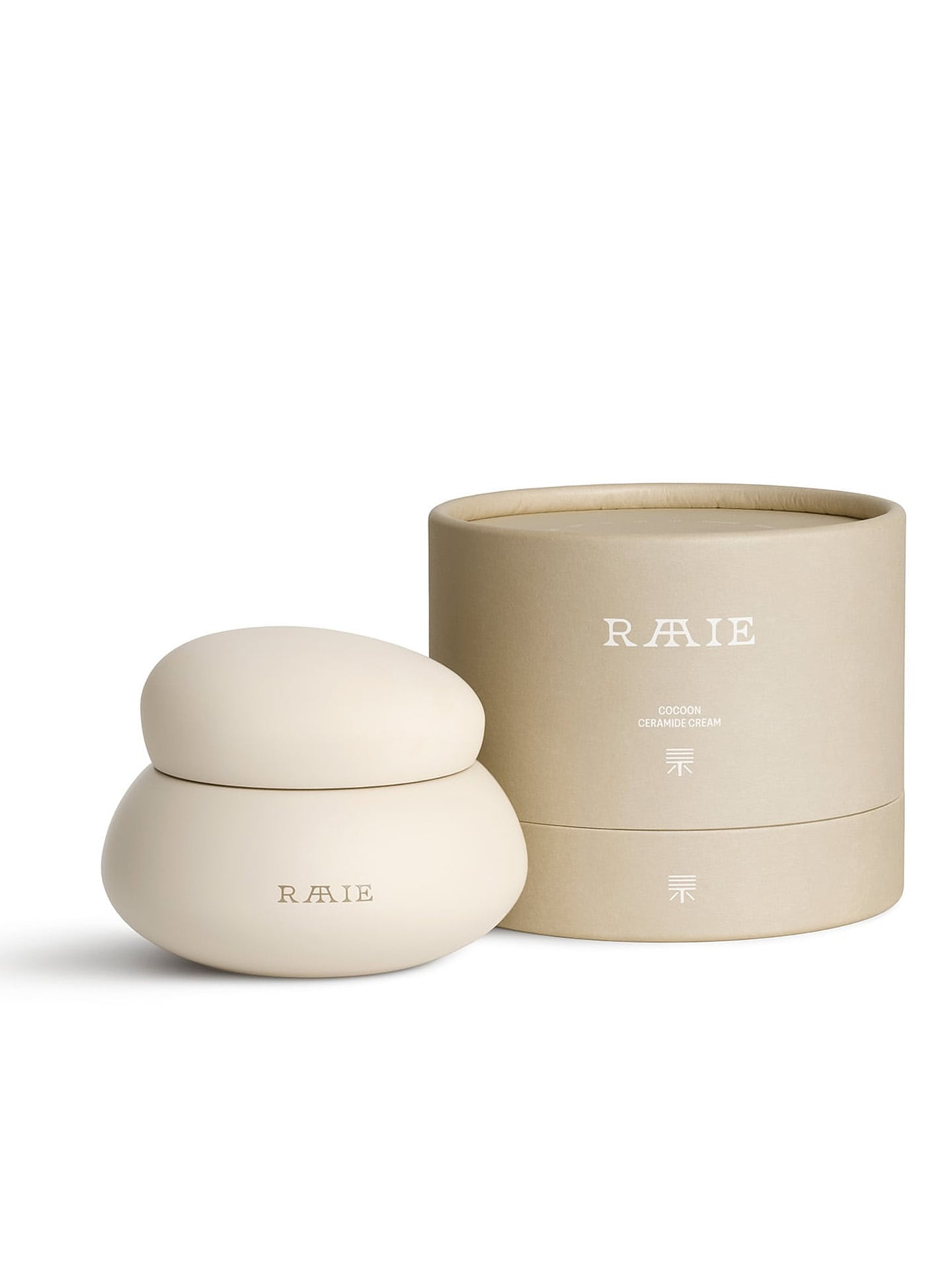 A round, beige container labeled "RAAIE" sits next to its matching cylindrical box. The box features the brand name "RAAIE" and minimal text, indicating it houses a hydrating moisturizer called Cocoon Ceramide Cream designed to reinforce the skin barrier with essential ceramides.