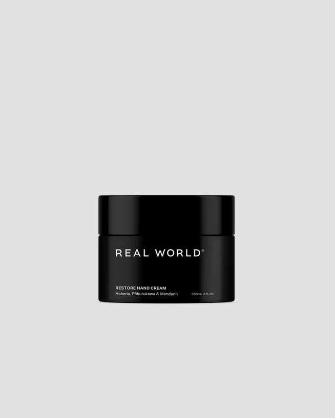 A soothing black jar with the words Repair Hand Cream – Hoheria, Pōhutukawa &amp; Mandarin by Real World on it.