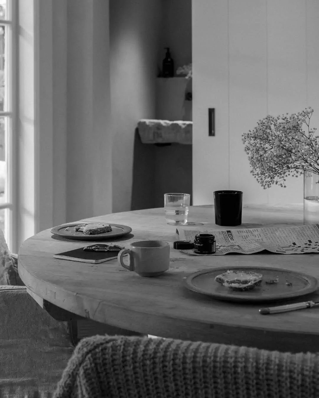 A restorative Real World Repair Balm – Kawakawa Balm with Mānuka and Mamaku black and white photo of a dining room table.