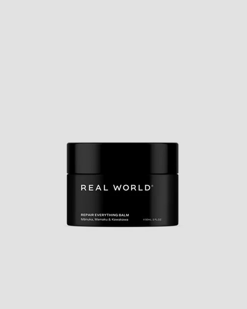 A restorative black jar with the words &quot;Repair Balm – Kawakawa Balm with Mānuka and Mamaku&quot; by Real World on it.