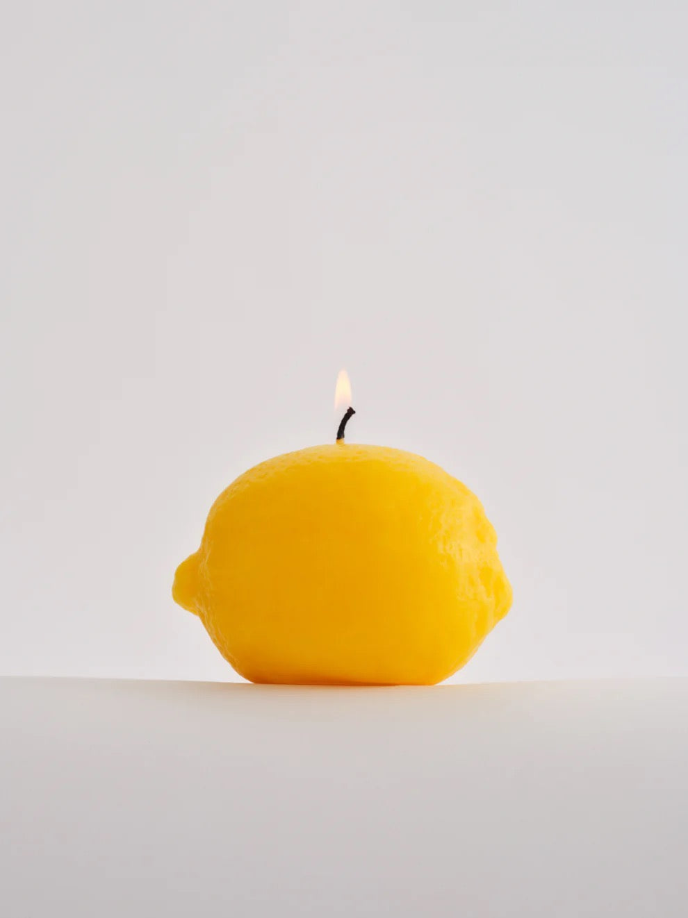 A Nonna's Grocer Lemon Candle made of a soy wax blend.