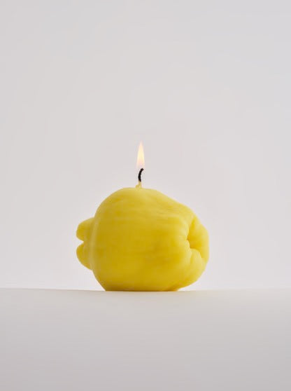 A Quince Candle handmade by Nonna's Grocer, featuring a lemon shape.