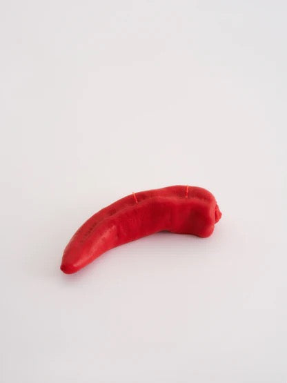 A Red Chilli Candle hand finished on a white surface from Nonna&#39;s Grocer.