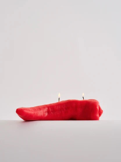 A Nonna's Grocer Red Chilli Candle is sitting on a white surface.