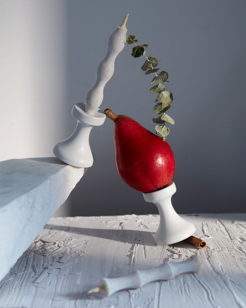 A FLUID – Stoneware Candle Holder from Takazawa with a pear on top.