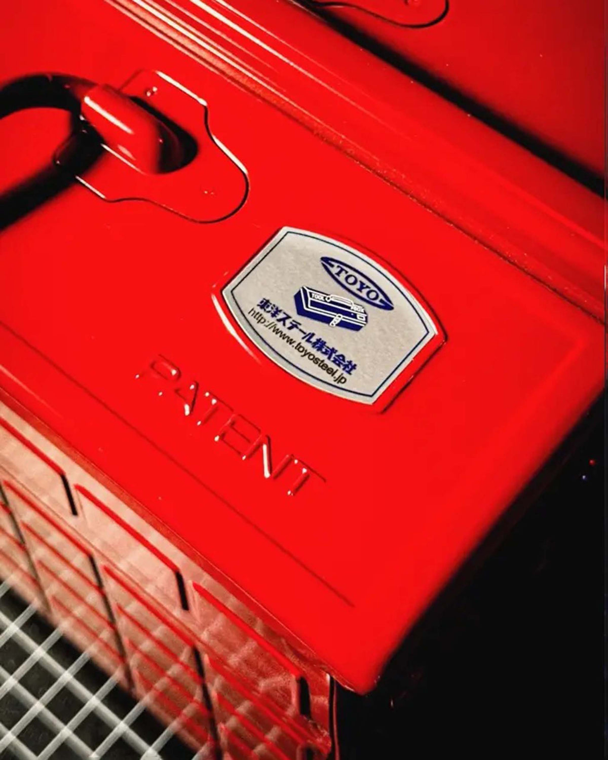 A bright red metal toolbox with a Toyo label and the word “PATENT” embossed on the lid.