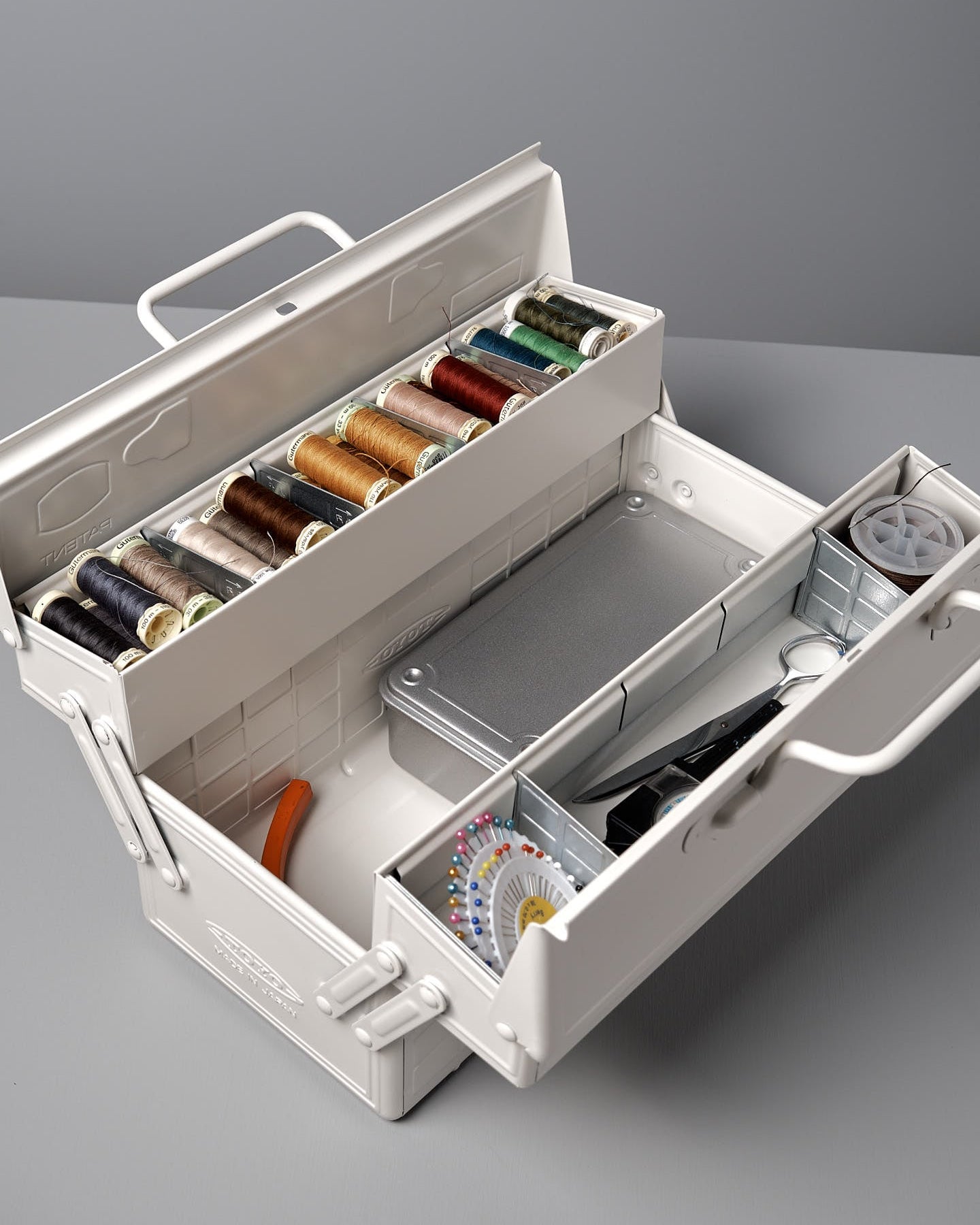 A white, rectangular powder-coated steel toolbox with a handle on top and a latch on the front, placed against a gray background. The Cantilever Toolbox ST-350 – White by TOYO STEEL earned the prestigious Good Design Award 2009.