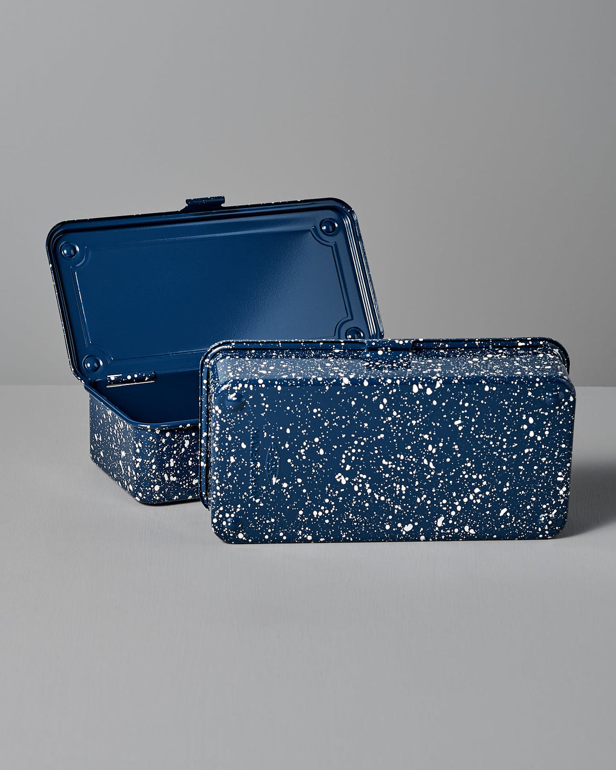 Two Mini Steel Toolboxes T-190 in Japanese Indigo from TOYO STEEL, one open and one closed, showcasing a versatile design on a gray surface.