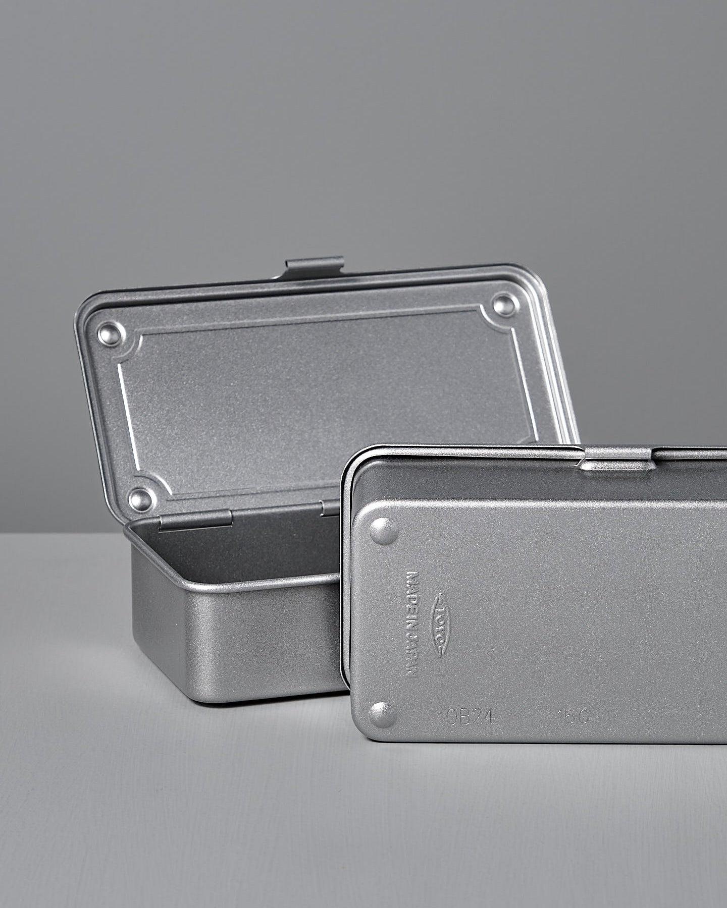 The TOYO STEEL Mini Steel Toolbox T-190 – Silver is a closed, rectangular metallic box with a latch that sits on a flat surface against a plain background.