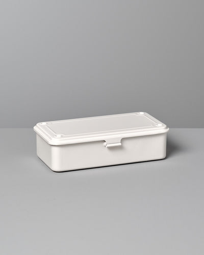 A Mini Steel Toolbox T-190 – White from TOYO STEEL with a closed lid, placed on a gray surface against a gray background.