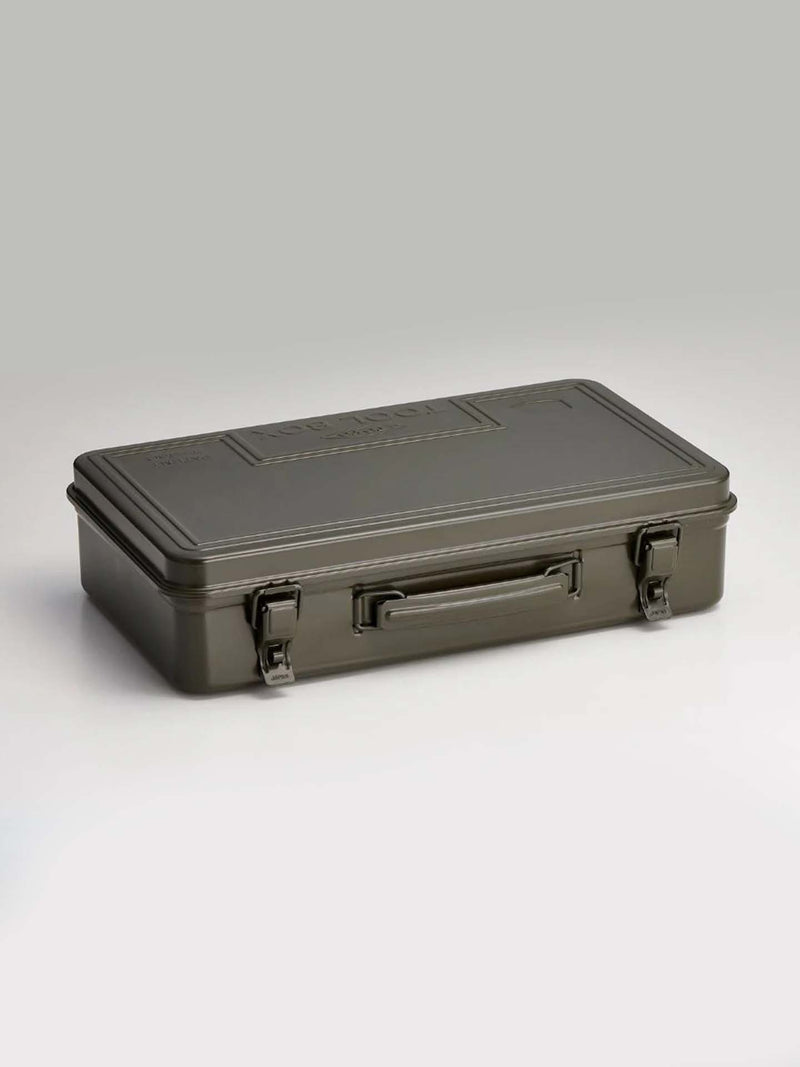 The Trunk-style Toolbox T-360 in moss green, a closed rectangular metal box with handle and two latches for practical storage, is set on a plain surface against a neutral background.
