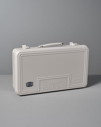 The Trunk-style Toolbox T-360 – White by TOYO STEEL, made from powder-coated steel and featuring an embossed "TOOL BOX" with a patent number, offers an excellent storage solution set against a gray background.