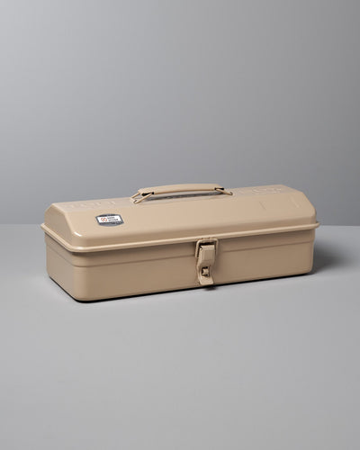 A versatile storage solution, the Camber-Top Toolbox Y-350 – Beige by TOYO STEEL, made in Japan, features a sturdy latch and a practical handle on top. It's elegantly placed on a grey surface against a grey background.