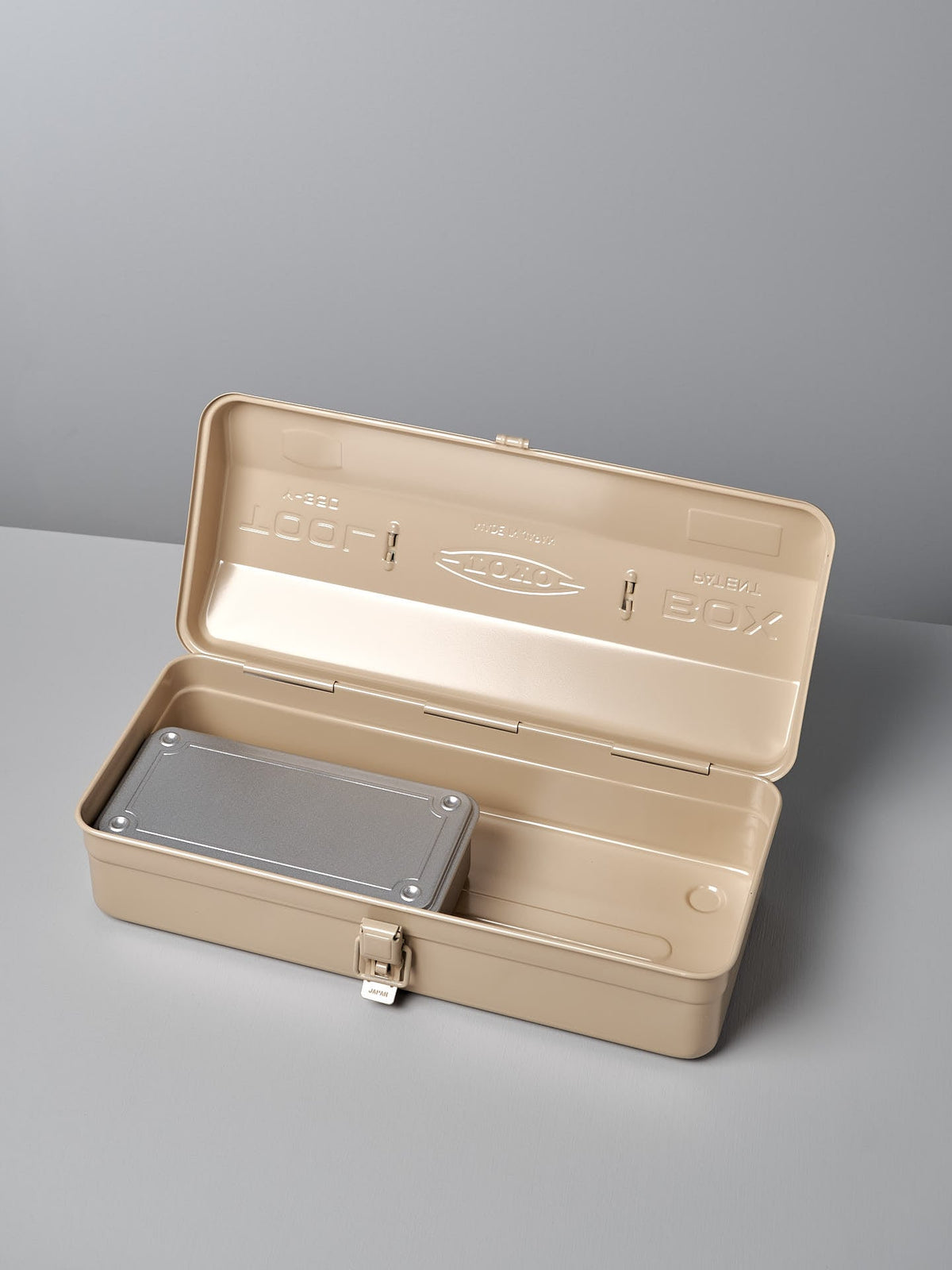 A beige metal toolbox with the lid open reveals a Camber-Top Toolbox Y-350 – Beige by TOYO STEEL inside, showcasing its thoughtful design and craftsmanship made in Japan.