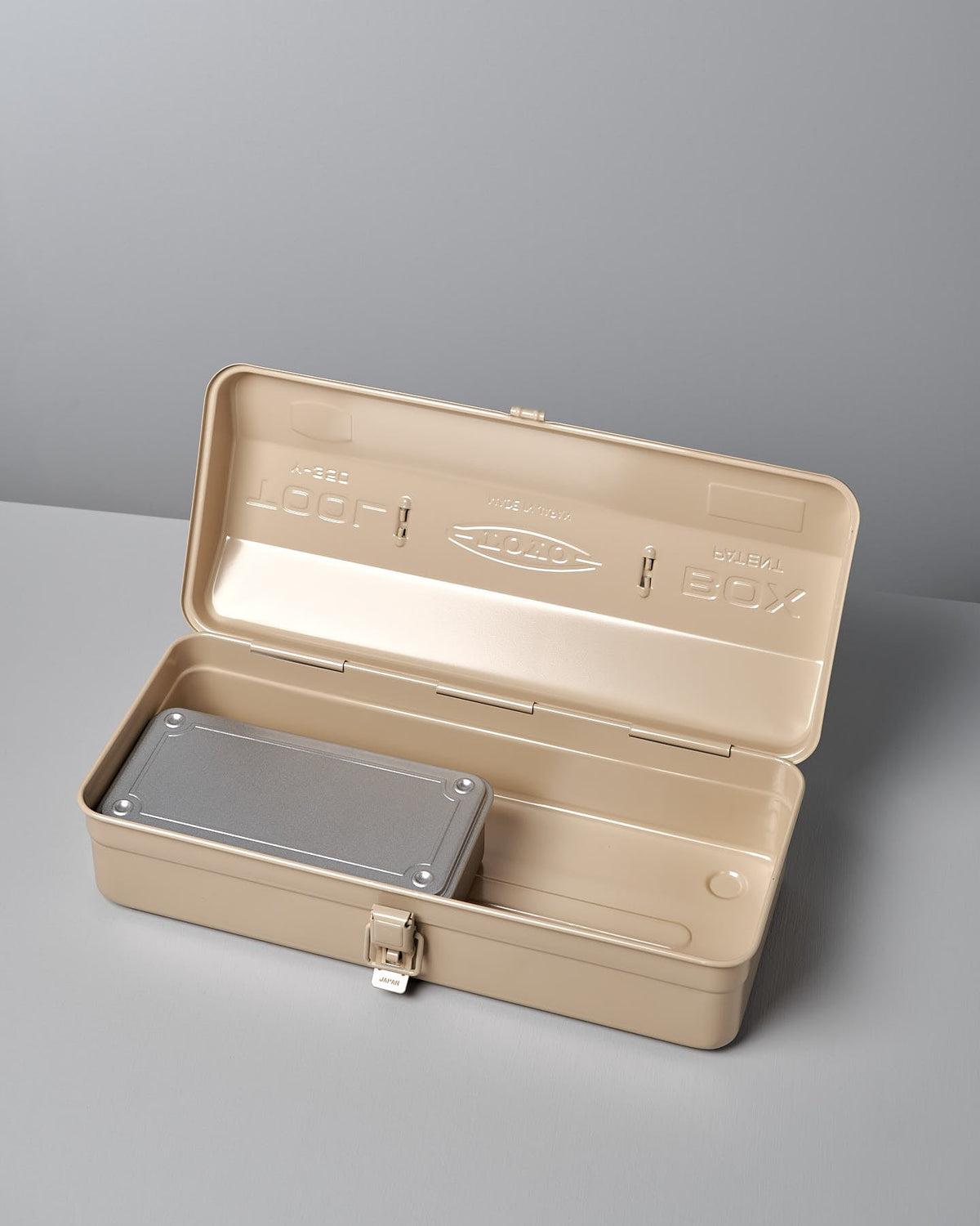 A beige metal toolbox with the lid open reveals a Camber-Top Toolbox Y-350 – Beige by TOYO STEEL inside, showcasing its thoughtful design and craftsmanship made in Japan.