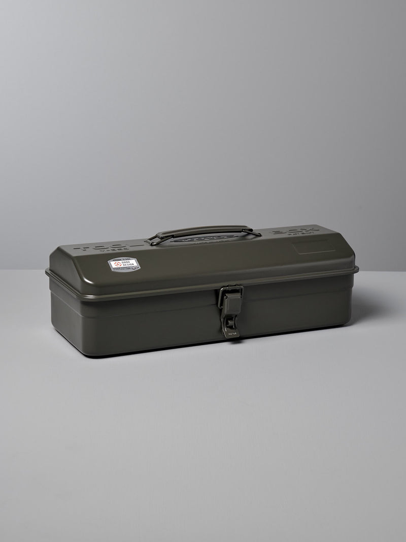 A closed, rectangular, dark green metal Camber-Top Toolbox Y-350 – Moss Green made by TOYO STEEL in Japan with a handle and a latch, sits on a light grey surface.