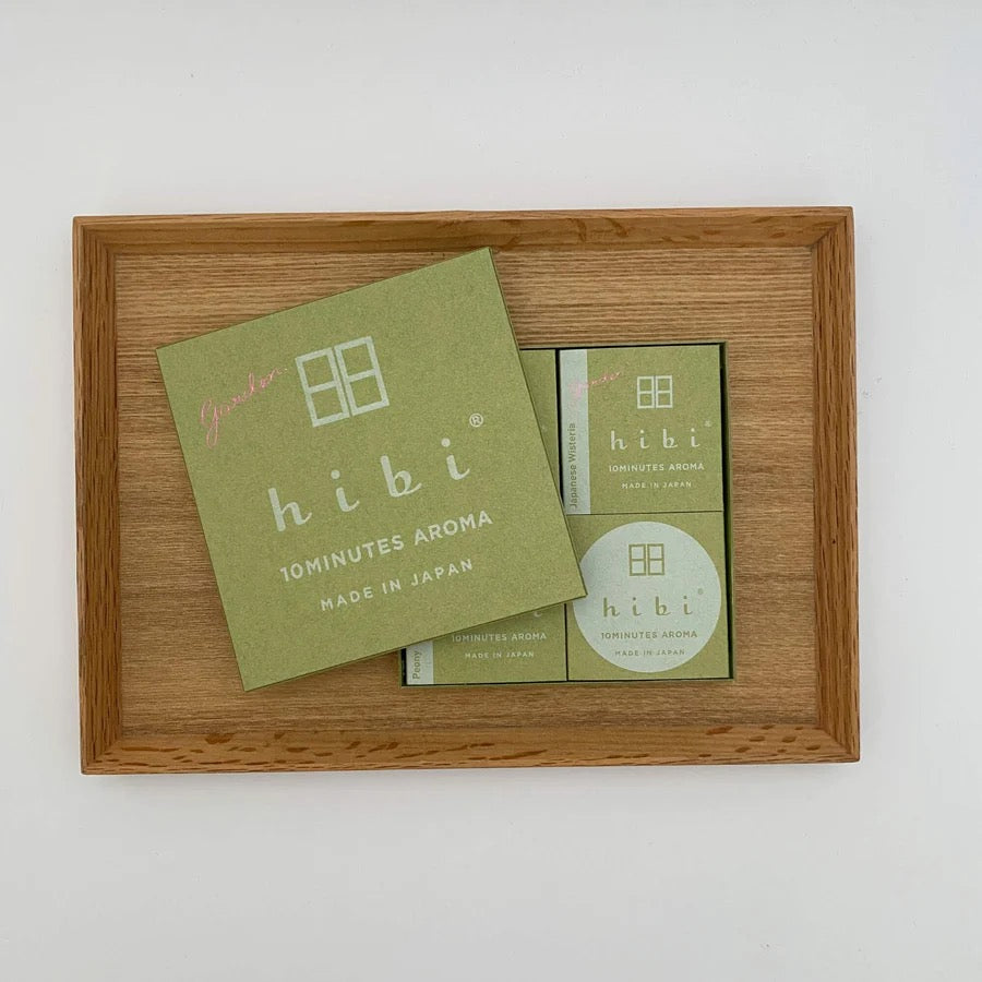 A wooden tray with a box of hibi Match Box Incense – Garden Scent Gift Box products on it.