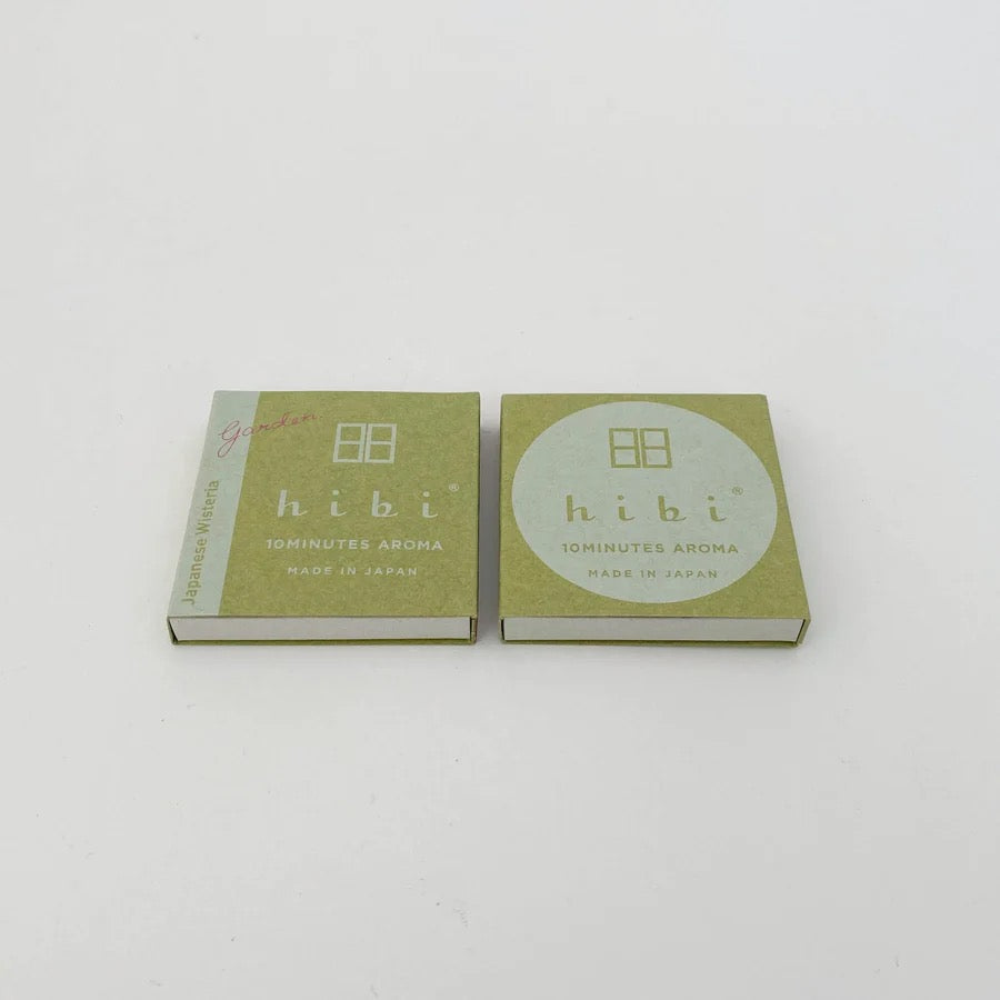 Two hibi Match Box Incense Garden – Japanese Wisteria on a white surface.