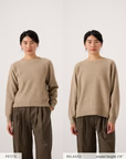 Side-by-side images show a woman wearing the Nimbus Raglan Knit – Truffle with brown pants; the left features a Petite fit, while the right displays a relaxed fit matching set.